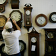 Mark Brown adjusts clocks on the wall at Brown?s Old Time Clock Shop March 6, 2007 in Plantation, Florida.